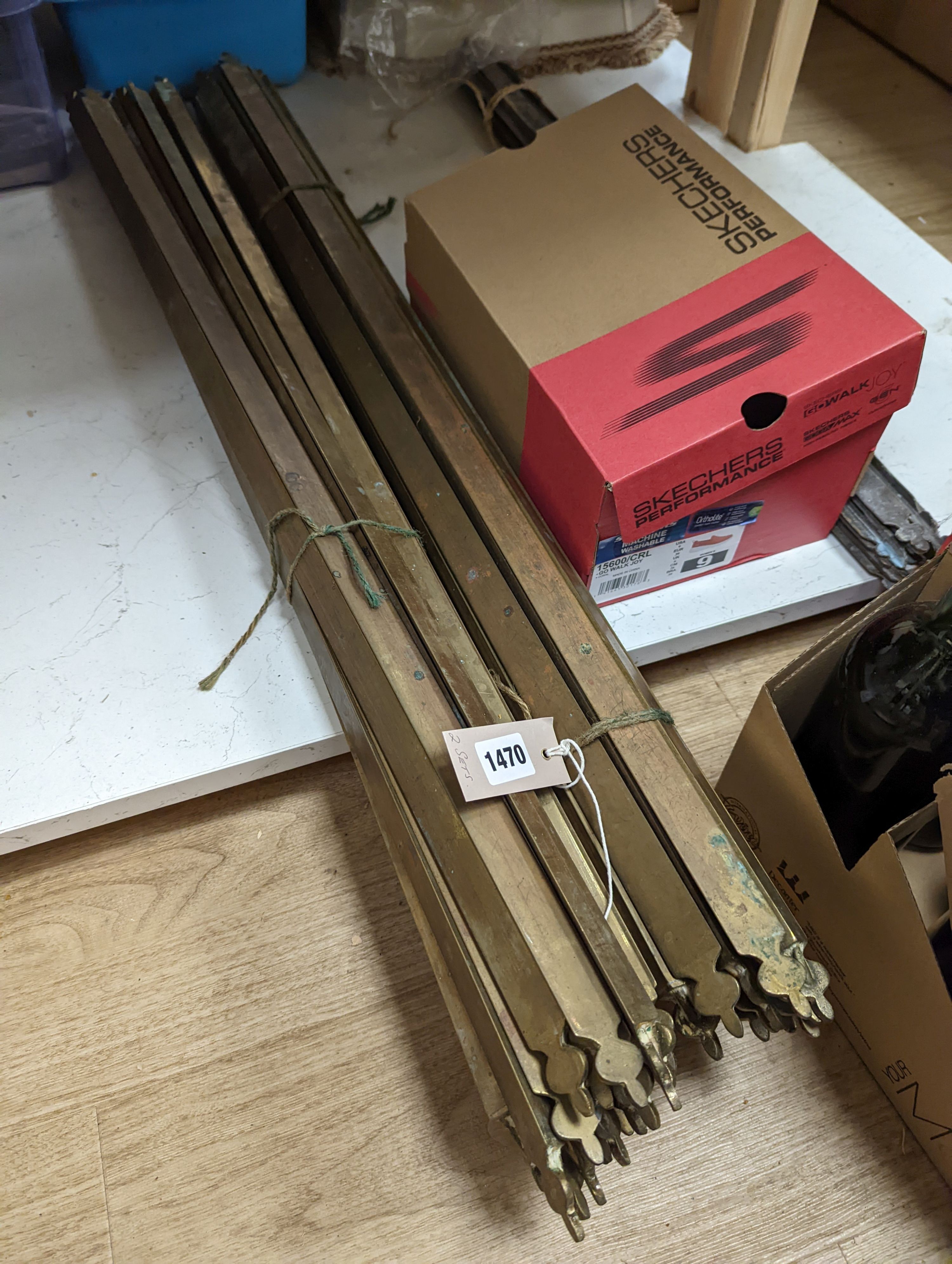 Two sets of brass stair rods with fittings.